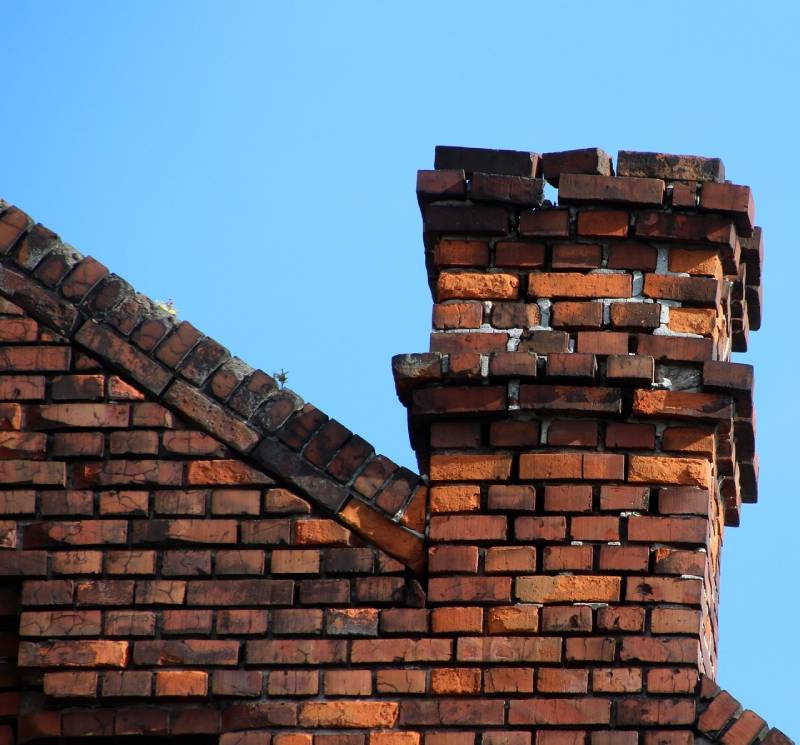 Damaged chimney on an Melrose Park home showing cracks and missing mortar